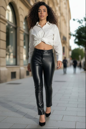 Hilda Leather Aster black lambskin leather pants in a jean-style silhouette worn with a white button-down shirt.