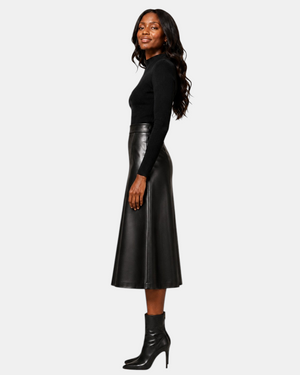 Hilda Leather Viola black lambskin leather A-line midi skirt worn by a model with a black turtleneck and boots