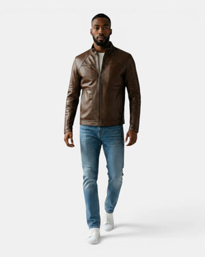 Model wearing a Hilda Leather brown napa lambskin sport jacket with a stand-up collar, jeans, and white sneakers.