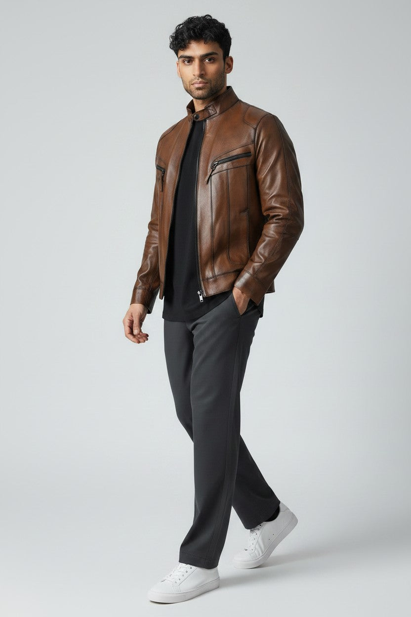 Man wearing the Metin2 brown leather jacket, black shirt, gray pants, and white sneakers on a light gray background - Hilda Leather Turkey