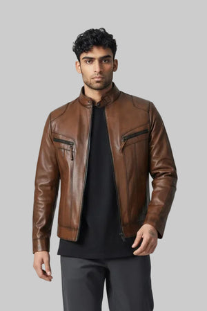 Man wearing Metin2 brown leather jacket, black shirt, gray pants, and white shoes on a light gray background front view – Hilda Leather Turkey