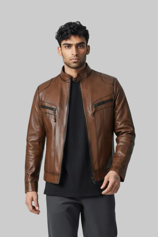 Man wearing Metin2 brown leather jacket, black shirt, gray pants, and white shoes on a light gray background front view – Hilda Leather Turkey
