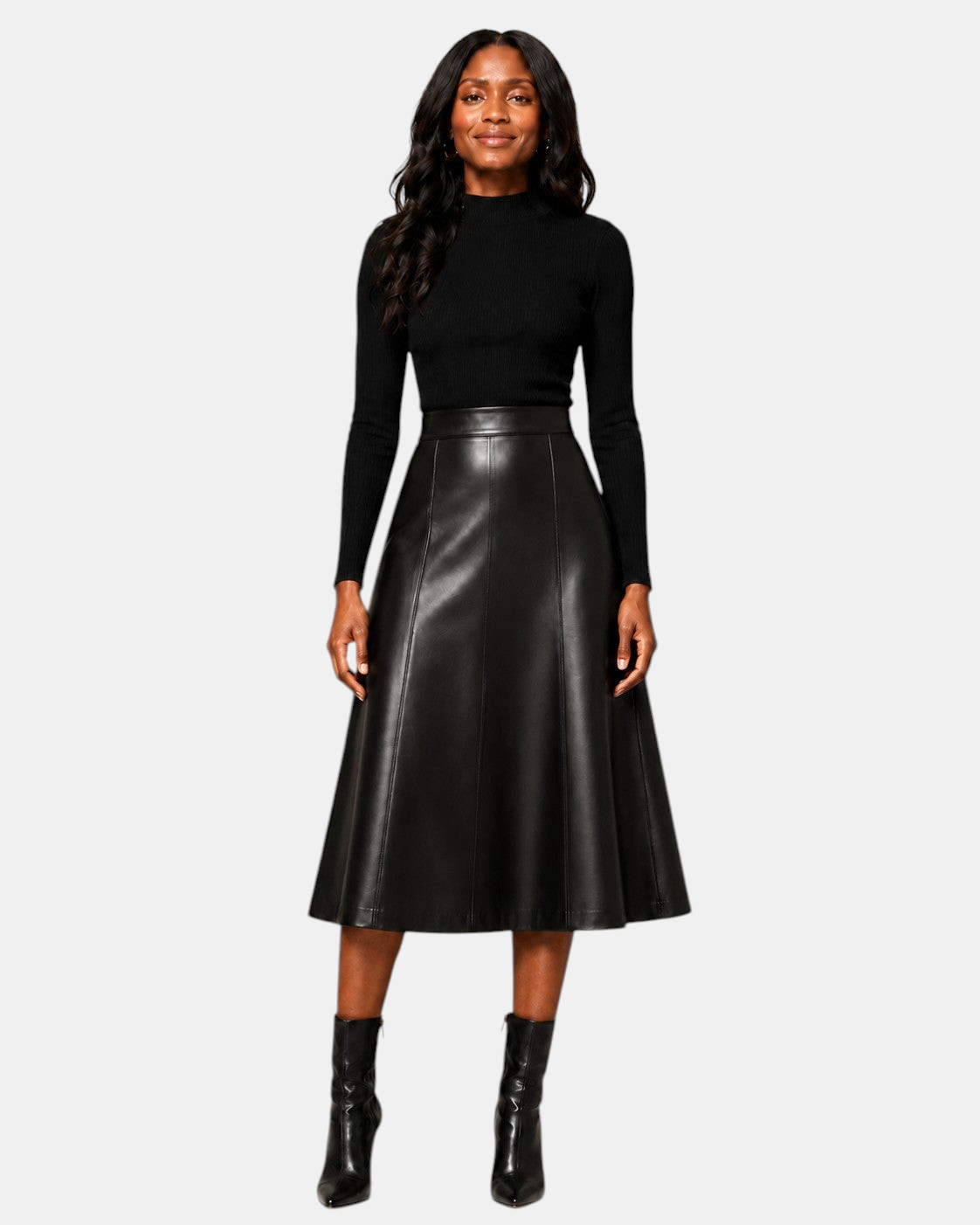Model wearing a Hilda Leather black lambskin A-line midi skirt with a high waist and vertical panel detailing.