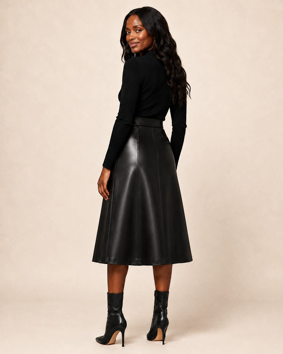 Hilda Leather black lambskin midi skirt with A-line silhouette and panel detailing worn by a model.
