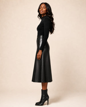 Model wearing a Hilda Leather black genuine lambskin A-line midi skirt with a high-waisted fit and structured panels.