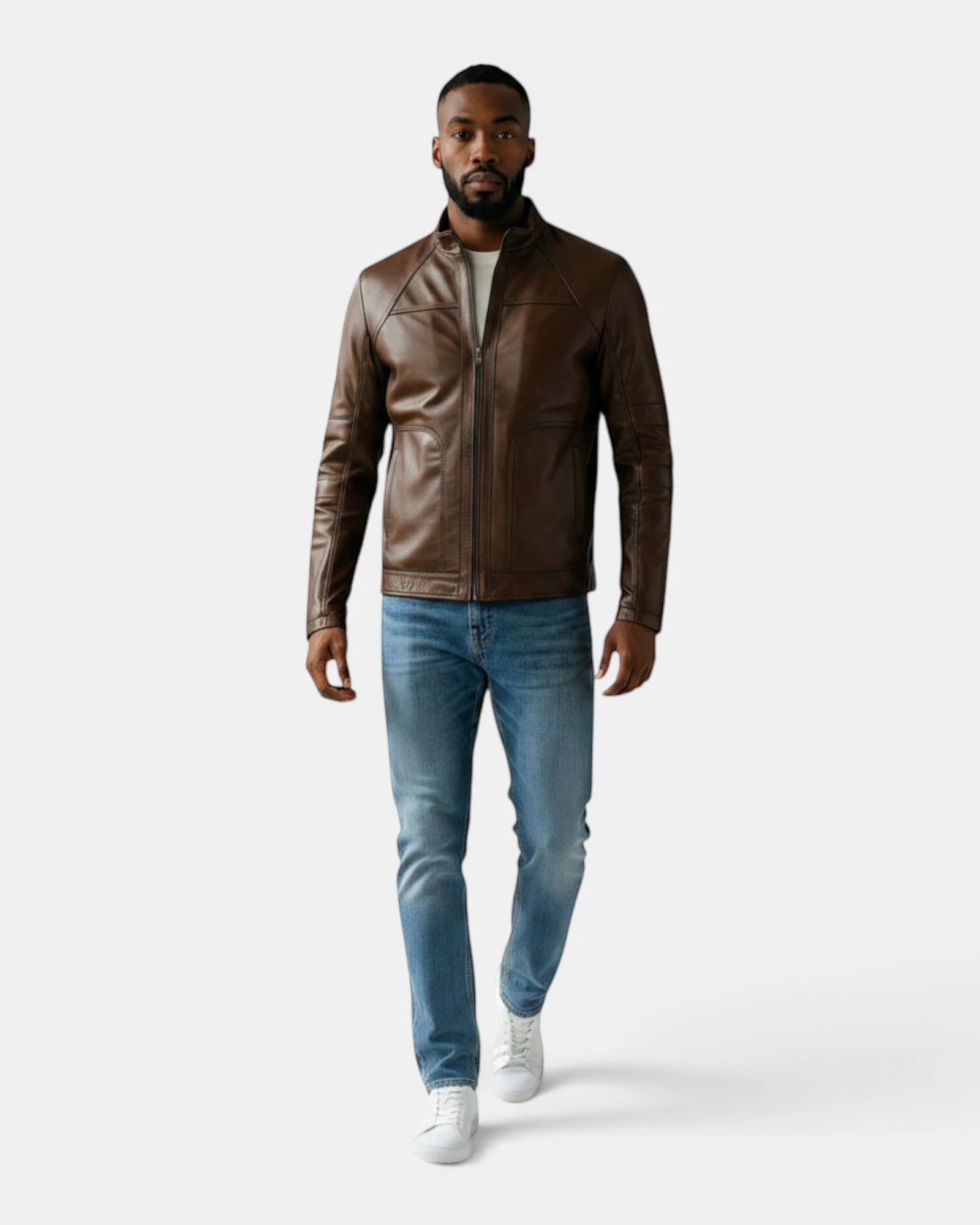 Model wearing a Hilda Leather brown napa lambskin sport jacket with a stand-up collar, jeans, and white sneakers.