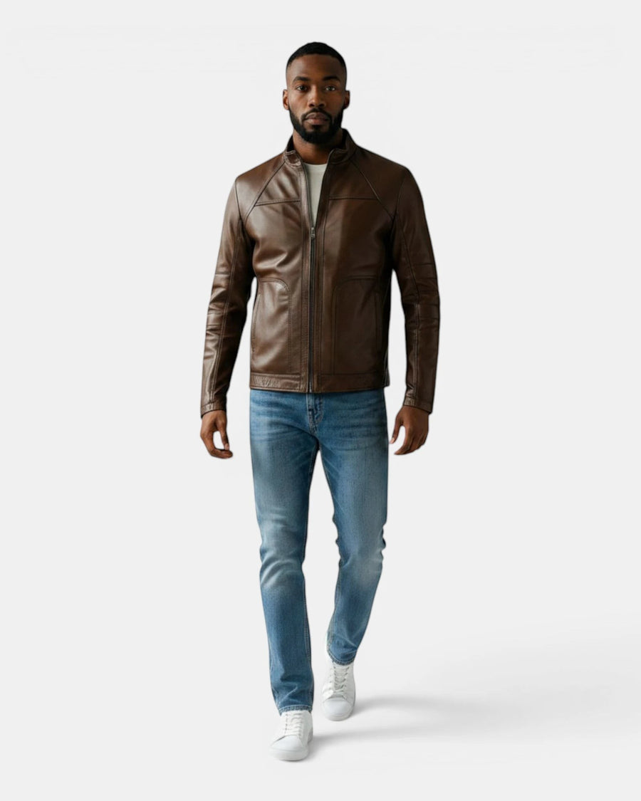 Model wearing a Hilda Leather brown napa lambskin sport jacket with a stand-up collar, jeans, and white sneakers.