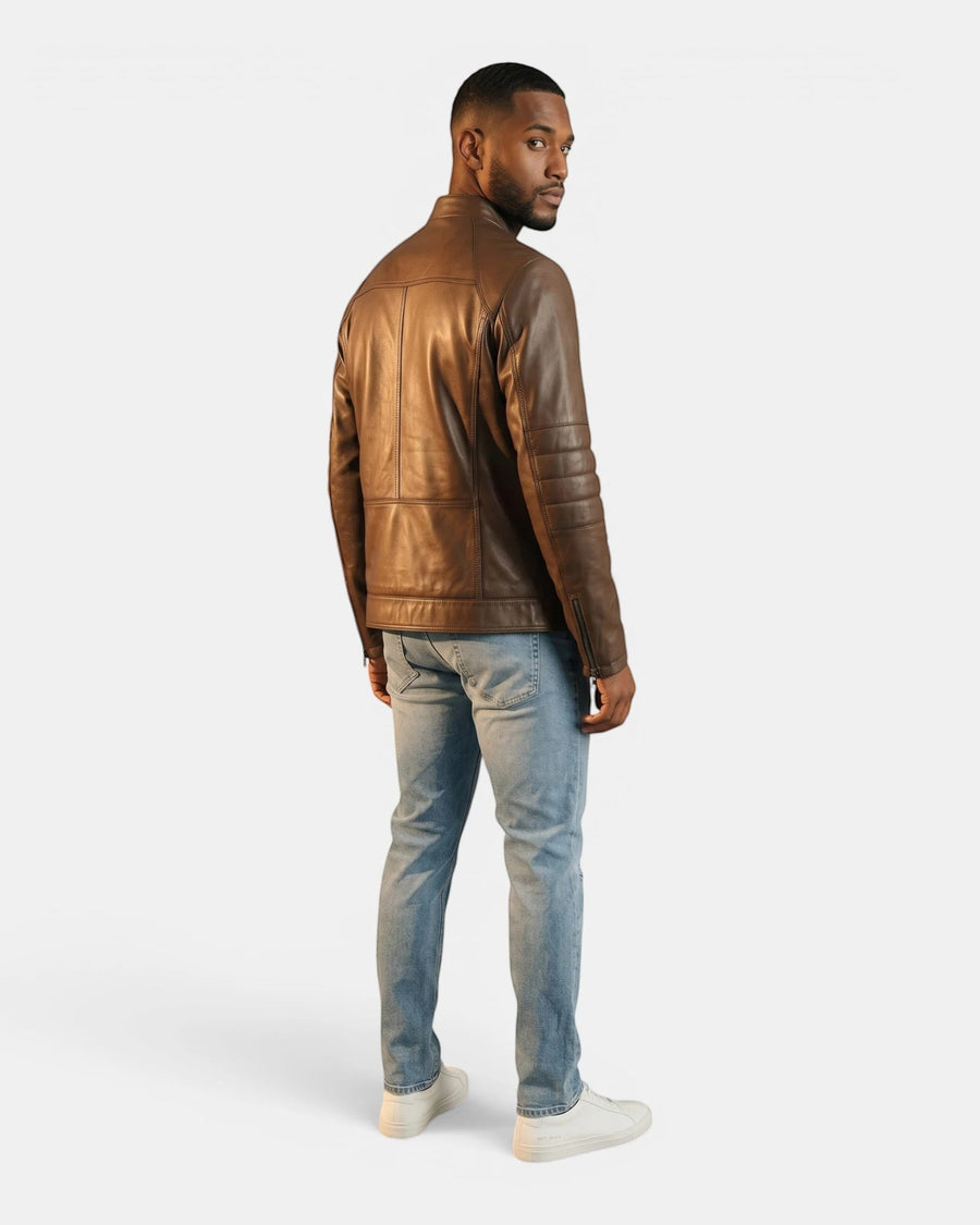 Model wearing a Hilda Leather brown napa lambskin sport jacket with a stand-up collar, back view, paired with jeans.