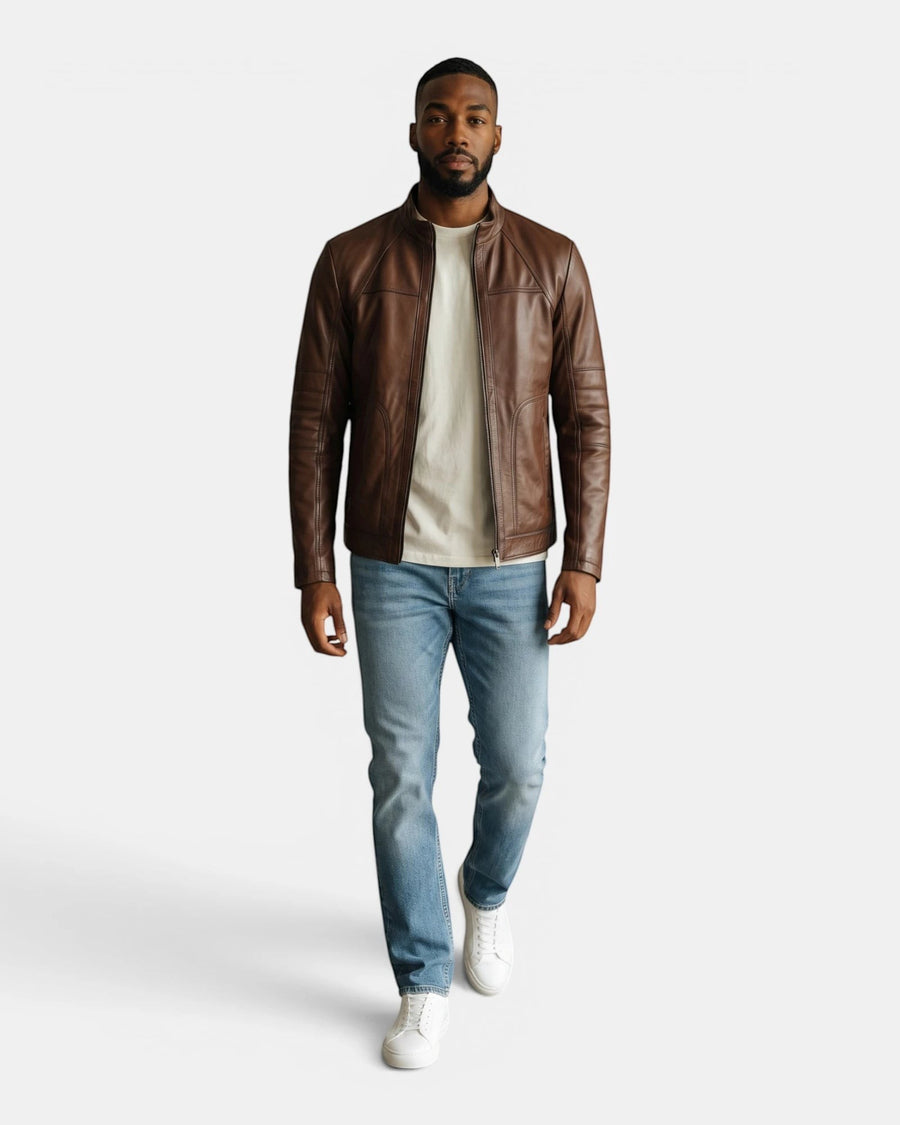 Model wearing a Hilda Leather brown napa lambskin sport jacket with a stand-up collar, jeans, and white sneakers.