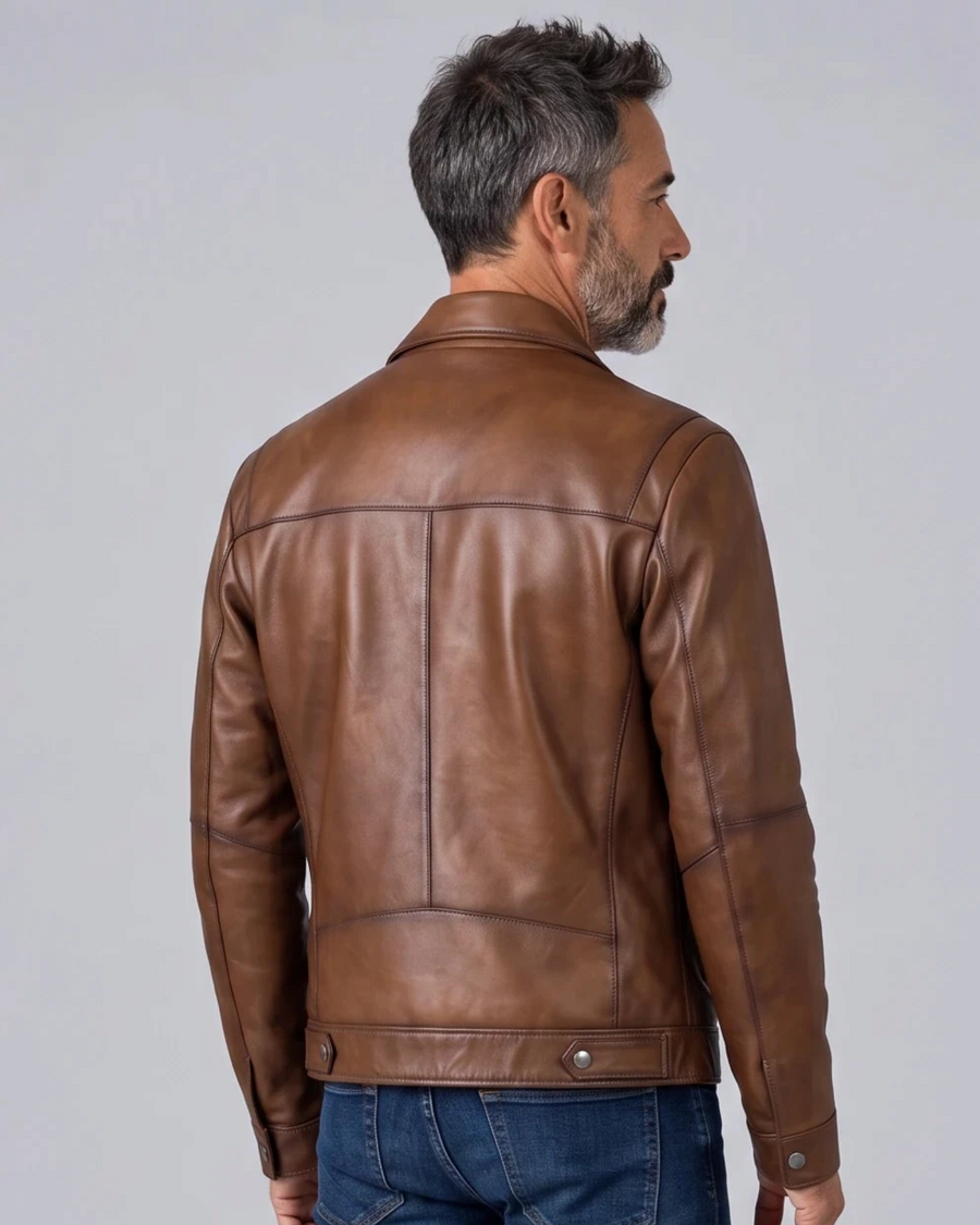 Back view of a man wearing a Hilda Leather shadow brown lambskin jacket with a clean, regular fit design.
